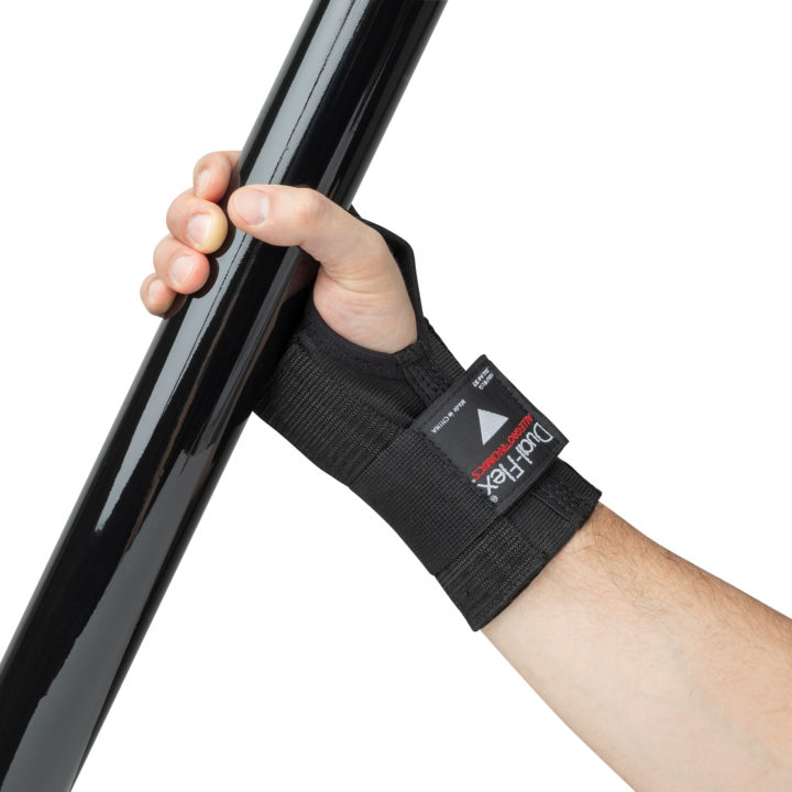 Black Dual-Flex Wrist Support on model's wrist holding black metal pipe